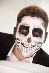 Man with make-up Halloween. Drawing a vampire, skeleton