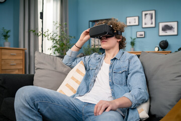 Young man in casual clothes wear the virtual reality glasses is watching and showing imagine via the VR camera, Technology and innovation concept