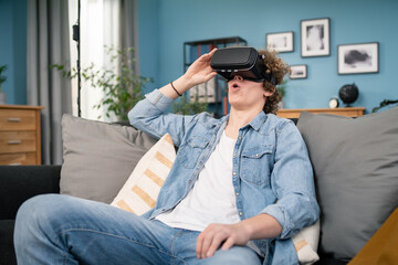 Young man in casual clothes wear the virtual reality glasses is watching and showing imagine via the VR camera, Technology and innovation concept