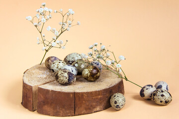 Easter eggs on a wooden cylindrical shape on a beige background Minimal eco concept of Easter