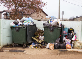 Full trash can. Trash can filled with trash. Trash can packed to overflowing with rubbish. The bin is filled with rubbish.