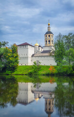 Fototapeta na wymiar View of St. Paphnutius of Borovsk Monastery reflecting in water, Kaluga oblast, Russia
