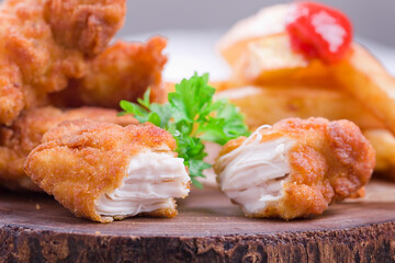 crispy chicken nuggets Crunchy homemade fries on a white napkin