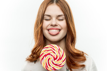 woman licking lollipop delight sweet candy light background