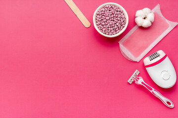 Cosmetics set for epilation with epilator and wax strips and flowers. Top view