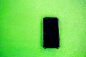 Black telephone, isolated on a light background.