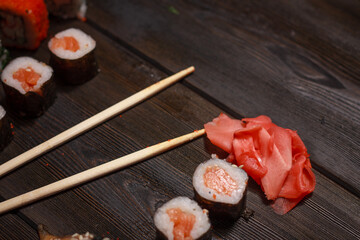 with sushi chopsticks ginger delicacy wooden background meal