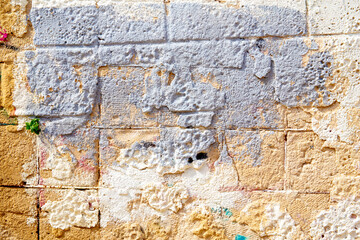 texture of a yellow and grey stone wall covered, space for text, space for copy