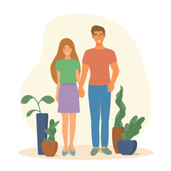 Happy young man and young woman. They are a happy couple, they are a young family. They are holding hands. There are pots of flowers.  
