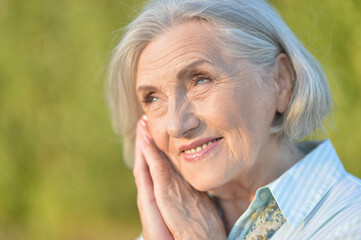 Portrait of a happy smiling senior woman in park