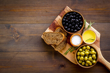 Fototapeta na wymiar Sliced bread ciabatta with olives and oil. Greek or Italian meal
