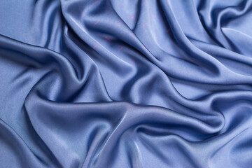 Fototapeta premium Blue silk or satin luxury fabric texture. Top view.