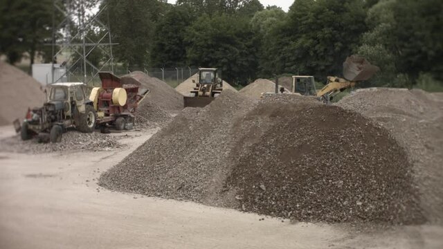 Excavator and stone splitter during the work