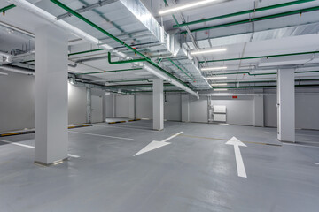 empty underground garage parking with columns and road markings
