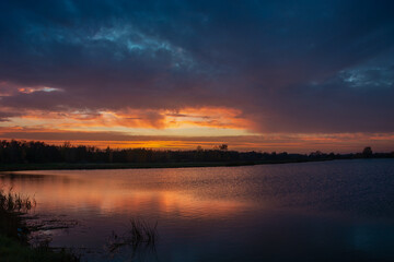 Naklejka na ściany i meble Colorful sky and clouds after sunset on the lake