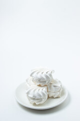 Marshmallow on a white background. White marshmallow on a white plate. Light dessert