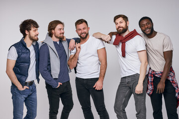Obraz premium multi-ethnic group of men in casual urban style clothes posing at camera