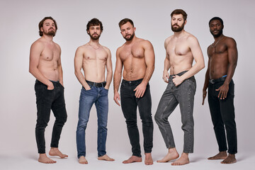 Portrait of shirtless diverse men posing seriously at camera, sexy guys in jeans - Powered by Adobe