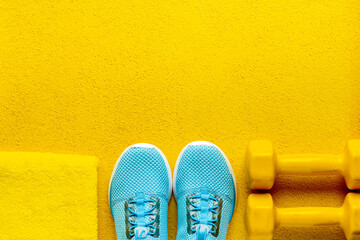 Athlete set of sneakers and bottle of water on bright blue background