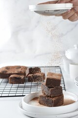 Homemade fudgy chocolate brownies on white background.