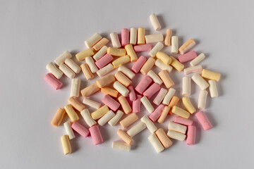 Colorful marshmallows on a light background. Close-up. Selective focus.