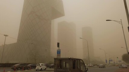 Sky turning orange as sandstorm and pollution hitting the city, Beijing, China.