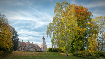 Fototapeta na wymiar Karsholm Castle with Autumn Trees