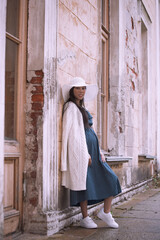Fototapeta na wymiar Young asian pregnant woman in white hat
