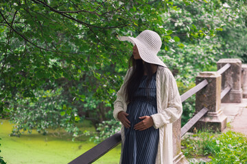 Obraz premium Young asian pregnant woman in white hat