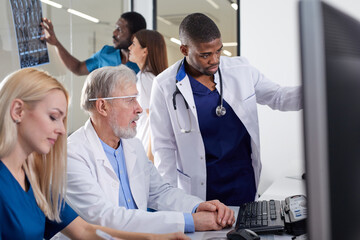 In Control Room Senior Doctor and Radiologist Discuss Diagnosis Using Monitors Showing Brain Scans Results