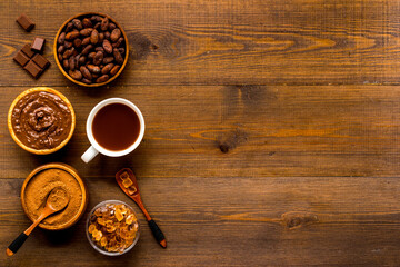 Cup of hot chocolate with coffee and cocoa beans, top view