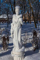 Snow covered white statue in the city park