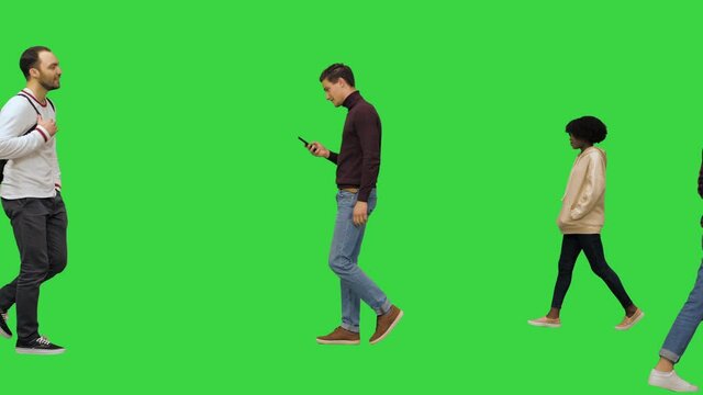 Big city life concept Rush hour, people crossing the street, drinking coffee, hurrying, walking, talking, texting messages on a Green Screen, Chroma Key.