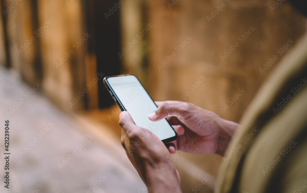 Poster cropped image on male holding mobile phone with mock up screen sending text messages and mails, man 