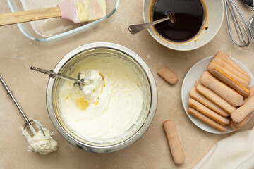 Mixing, whipping cream for cake. Cooking tiramisu cake with sponge fingers cookies. Step by step recipe.
