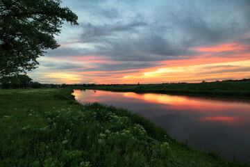 Obraz na płótnie Canvas Spring sunset by the river