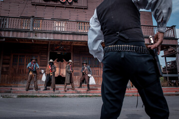 Cowboys group showing action success bank rob with gun and a lot of  money from rob the bank with white smoke vintage style background.