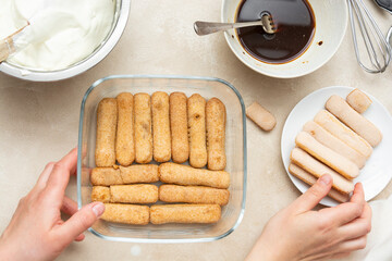 Cooking tiramisu cake with sponge fingers cookies. Step by step recipe. Top view.