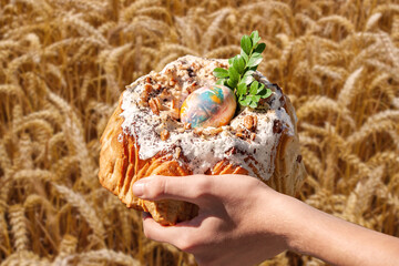 festive easter in hands on wheat background