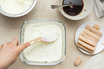 Cooking tiramisu cake with sponge fingers cookies. Step by step recipe. Top view.