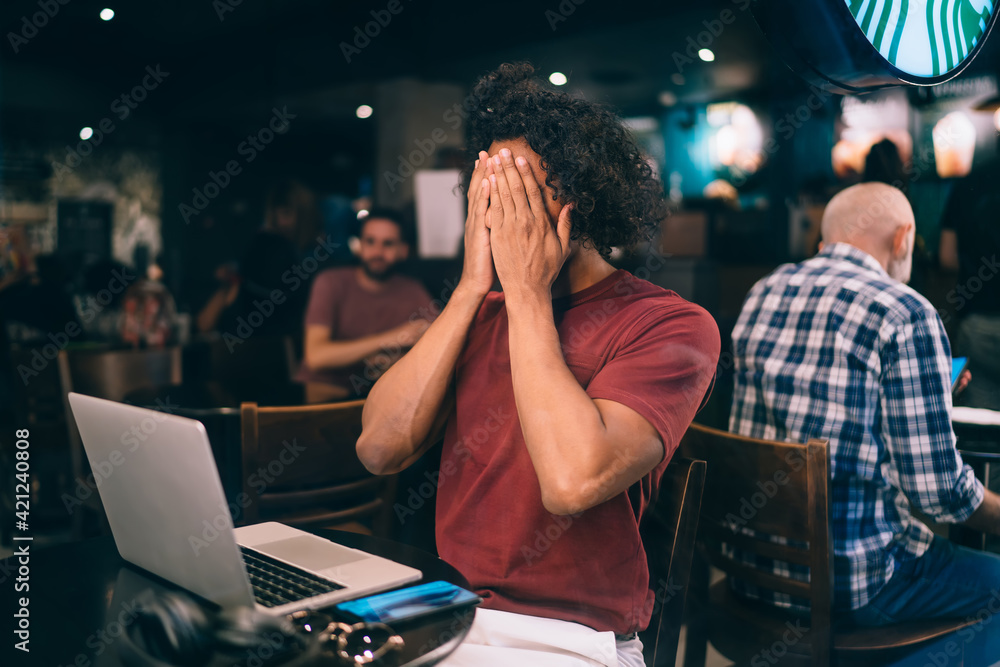 Poster curly male programmer feeling shame during remote working and web projecting have online mistake on 