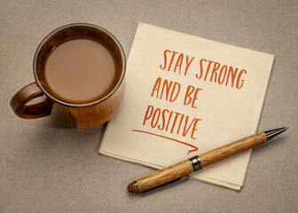 stay strong and be positive  inspirational handwriting on a napkin with a cup of coffee, positivity...