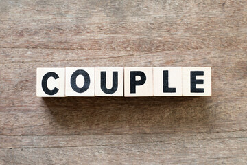 Alphabet letter block in word couple on wood background