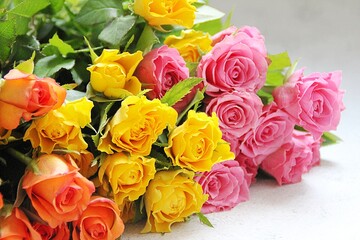 Fototapeta na wymiar colorful roses, yellow, orange and pink cut flowers, a bouquet of colorful roses, fragrant flowers