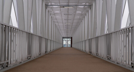 covered pedestrian bridge. selective focus. long tunnel.