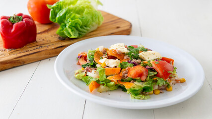 Close view  of  a fresh tasty salad on top of a white table