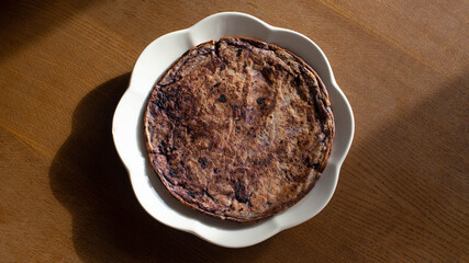 pancake with black berries lying on a plate