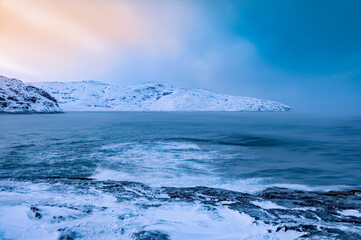 Scenic seascape of Barents Sea coastline in village Teriberka. Sunset arctic winter landscape in Murmansk region of Russia