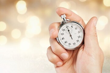 Classic metal stopwatch in human hand