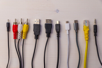 Various types of plugs and cables for audio, video, computer, smartphone and recharging connections. Evolution and change of the types of analog and USB connectors.